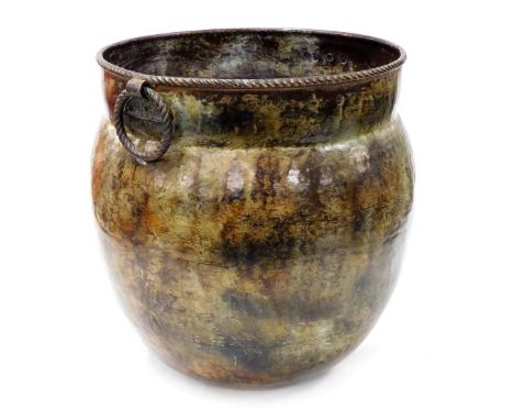 An Indian patinated copper pot, with double ring handles, 44cm high. 