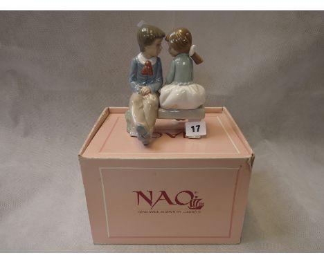 Boxed Nao figure of a boy and girl on a bench