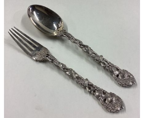 A Victorian silver vine pattern fork and spoon. London 1862. By George Adams. Approx. 95 grams. Est. £120 - £150.