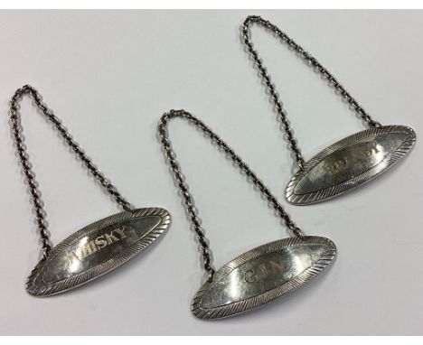 A set of three silver decanter wine labels for 'Gin', 'Brandy' and 'Whisky'. Birmingham 1966. By C&amp;C. Approx. 60 grams. E