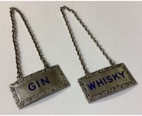 A pair of silver and enamelled decanter wine labels for 'Gin' and 'Whisky'. Birmingham 1954. By T&amp;S. Approx. 44 grams. Es