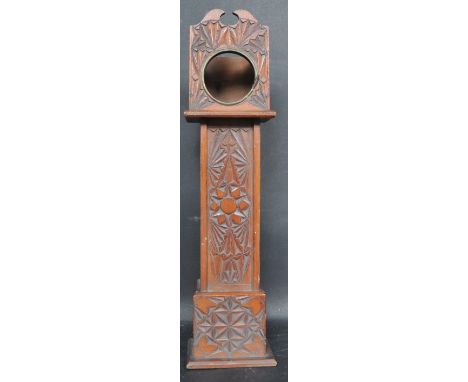 An early 20th century miniature grandfather clock having a swan neck pediment to the top floral and geometric patterns to the