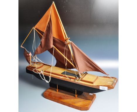 An early 20th Century scratch built hand made model boat ship having a single mast with four section sail. Detailed deck with