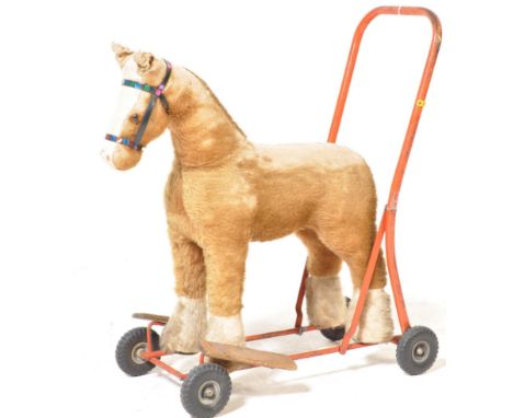 A vintage retro 20th century plush push along and ride on horse with applied label for International Model Aircraft Ltd to th