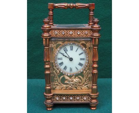 PRETTY FRENCH STYLE BRASS AND GLASS CARRIAGE CLOCK WITH ENAMELLED DIAL, DECORATED WITH ORMOLU AND CLEAR STONES 