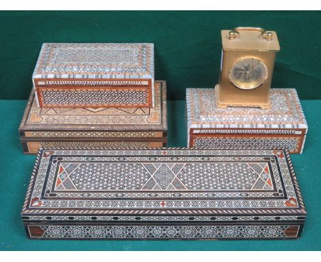 FOUR VARIOUS IVORY AND MOTHER OF PEARL INLAID STORAGE BOXES AND BRASS COLOURED CLOCK 