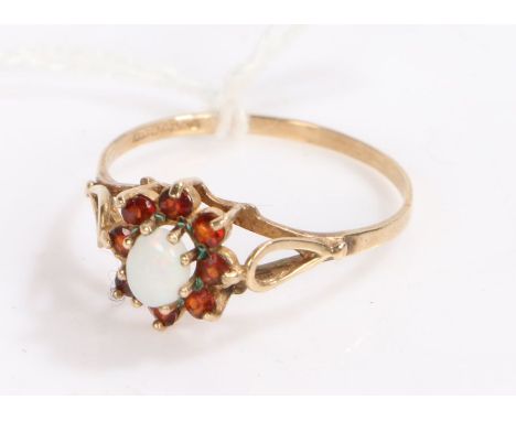 9 carat gold garnet and opal ring, with a central opal surrounded by eight garnets, ring size R gross weight 1.4 grams&nbsp;