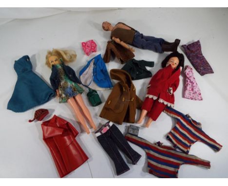 Sindy - Two original 1960's dressed Sindy dolls and a 1960's Action Man by Palitoy with a small quantity of clothing. Est £80