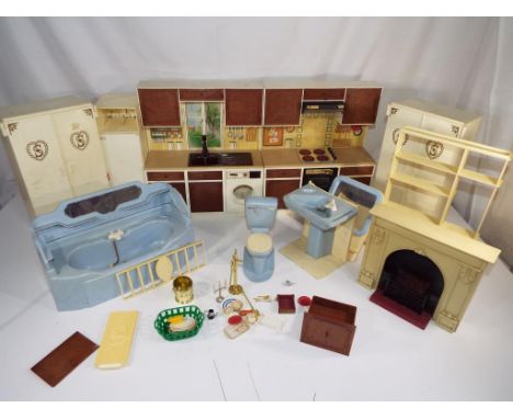 Sindy - A selection of vintage Sindy furniture comprising a fireplace, kitchen, cooker, two wardrobes, fridge, display unit a