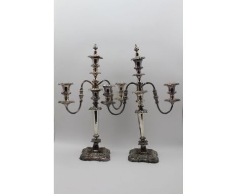 A PAIR OF SILVER PLATED TABLE CANDELABRA, triple light, twin branch design, with snuffing caps, 50cm high 