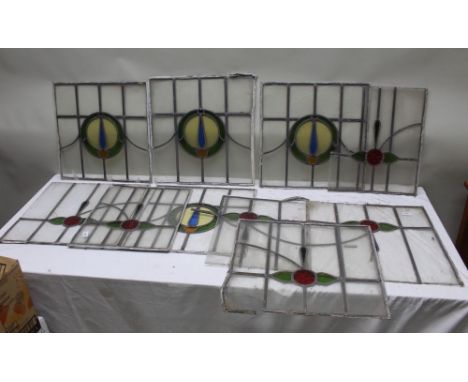 A COLLECTION OF TEN LEADED LIGHT WINDOW PANELS, central coloured glass details, 49cm square 