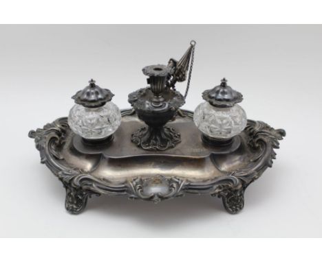 A WALKER & HALL EDWARDIAN SILVER STANDISH the acanthus leaf edged, the stand bears heraldic crest, having pen tray, two cut g