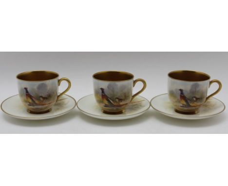THREE ROYAL WORCESTER PORCELAIN COFFEE CUPS & SAUCERS, each piece painted with pheasants in landscape, signed 'L.Maybury' (Le
