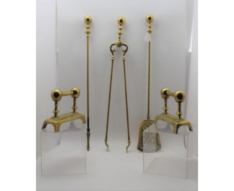 A SET OF THREE GEORGIAN DESIGN BRASS FIRESIDE TOOLS, comprising; poker, tongs, shovel with cast decoration, and a pair of and
