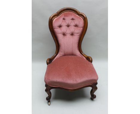 A 19TH CENTURY SHOW WOOD FRAMED BUTTON BACKED NURSING CHAIR in raspberry velour with scrolling knuckle forelegs, terminating 
