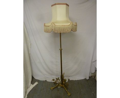 Brass standard lamp on tripod base with silk shade