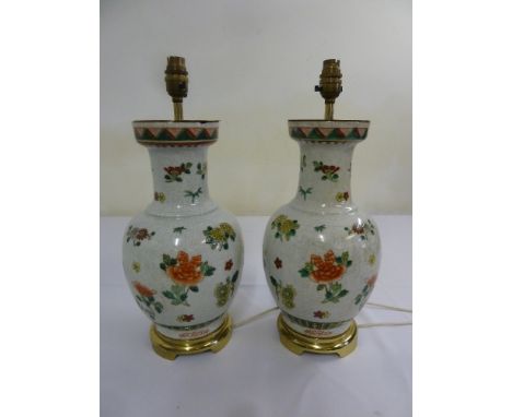 A pair of Chinese style crackle glazed lamp bases decorated with flowers and leaves
