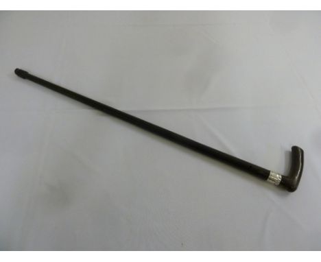 An ebonised walking stick with bone handle and silver ferrule