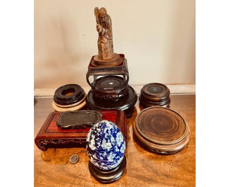 TEN VARIOUS STANDS, SOAPSTONE FIGURE AND CERAMIC EGG ON STAND

 