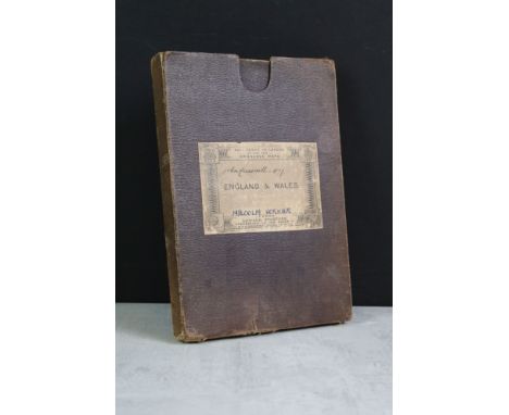An antique Edward Stanford Ordnance survey map of England and Wales in two sections and mounted to cloth, contained within fo