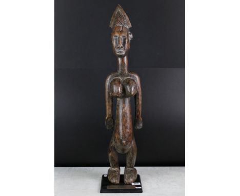 Carved hardwood South African figural golf trophy, modelled as a stylised nude female, raised on a square wooden base with pl