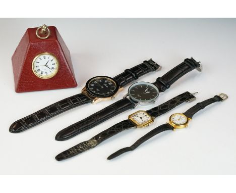 A weighted red leather Smythson desk clock together with a small group of watches. 