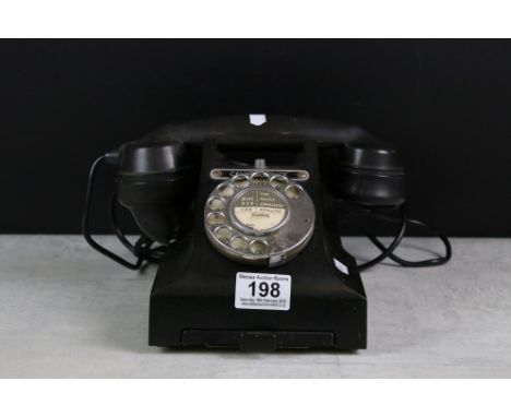 A vintage black telephone, marked 'Call Exchange' complete with lower drawer. 