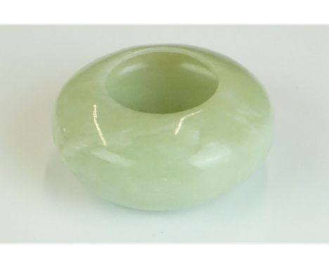 Chinese Jade Brush Washer of compressed circular form on a slightly raised base, 6.5cm diameter x 3cm high 