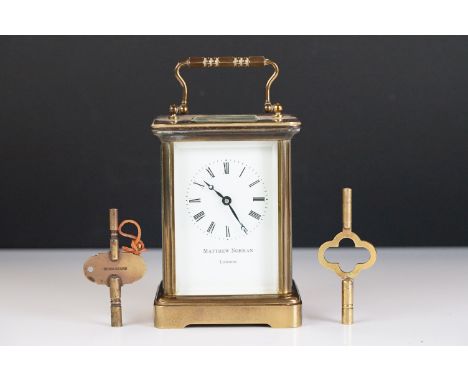 A brass cased carriage clock with bevelled glass panels, Matthew Norman of London, complete with key. 