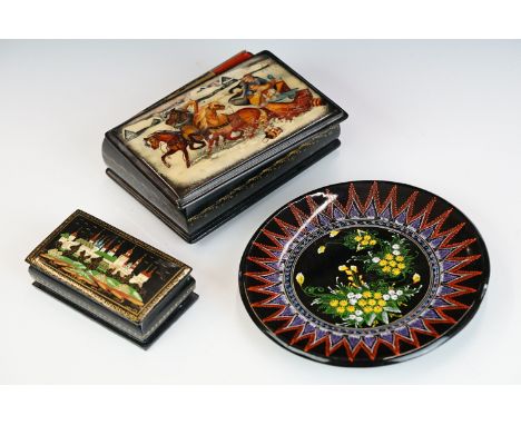 Two Russian lacquerware trinket boxes, both signed to the lids, together with a similar dish. 