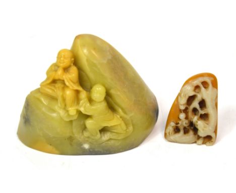 A Chinese carved soapstone small boulder decorated with two figures, width 8.5cm and a small soapstone carving depicting two 