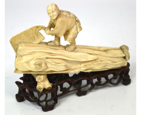 A good Japanese Meiji period Tokyo school ivory carving of a woodcutter modelled with a gentleman standing upon a large trunk