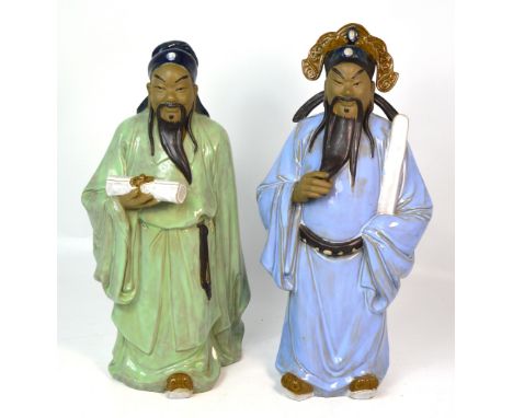 Two large 20th century Oriental ceramic figures, one in a green robe carrying a scroll and one in a pale blue robe with headd