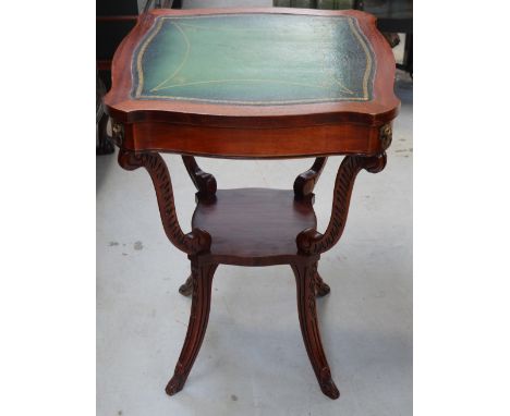 A reproduction mahogany leather topped side table with lower shelf on splayed carved legs, diameter 53cm.