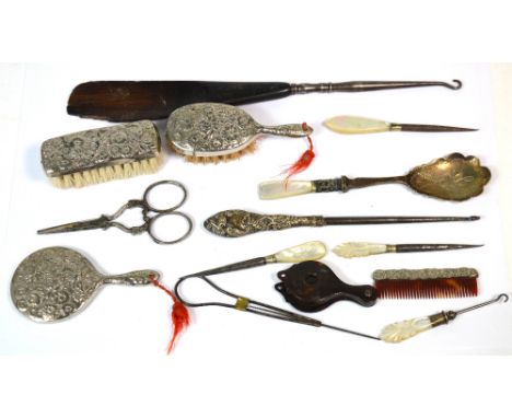 A small collector's lot to include a silver-handled button hook and various other button hooks with mother of pearl handles, 