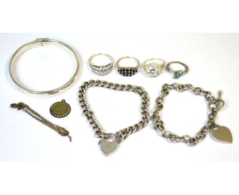 A hallmarked silver bangle, two silver link bracelets with padlock fastenings, four silver dress rings set with various stone