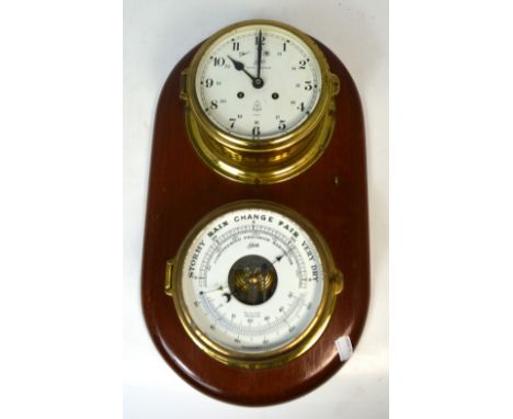 A brass Schatz Royal Mariner ship's clock and barometer set on a shaped wooden plaque, length 43cm.