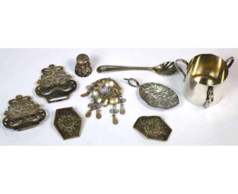 A small amount of plated ware to include tea caddy spoon, two nurse's buckles, a small plated triple-handled plated cup with 