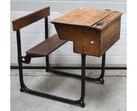 A vintage school desk with folding seat, width approx 56cm. CONDITION REPORT Light graffiti to surfaces.