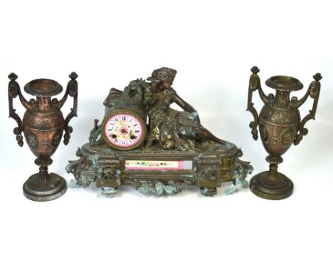 A 19th century metal and enamel clock garniture decorated with swags and flowers and a classical lady seated reading a large 