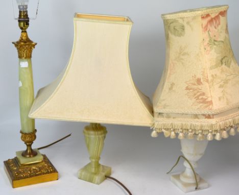 An early 20th century standard lamp with reeded column and floral shade, an onyx and gilt table lamp, and two other non-match