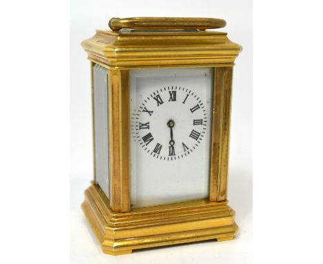 An early 20th century small brass carriage clock the enamel dial set with Roman numerals height 8cm.