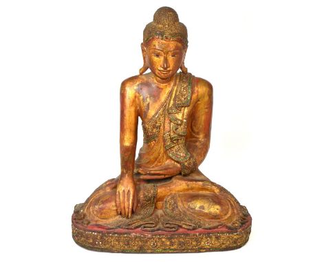 A c.1900 carved, gilded and 'jewel' set seated Buddha wearing elaborate cloak and on shaped base, height 48.5cm. *Provenance: