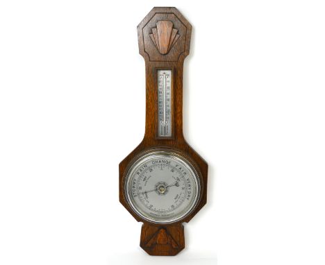 A mid 20th century oak aneroid barometer length 62cm.
