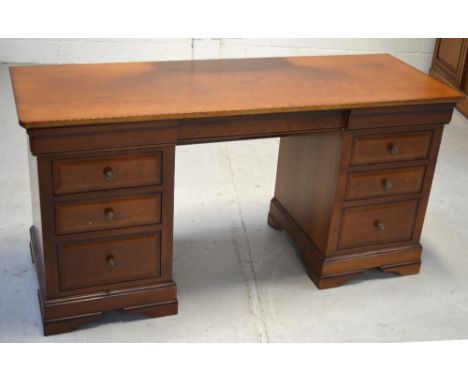 A 20th century mahogany kneehole desk, three drawers either side on bracket feet, length 151cm.