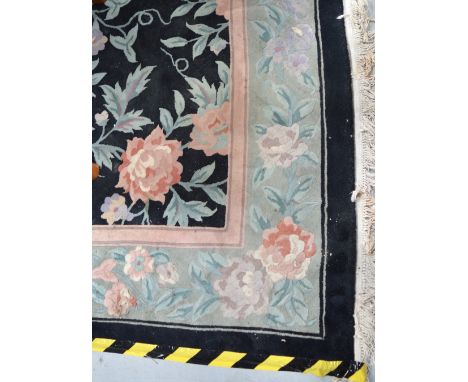 A large black ground floral decorated Chinese Superwash carpet, 390 x 275cm. CONDITION REPORT No wear to the pile, generally 