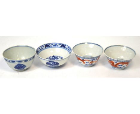 A pair of late c.1900 Chinese blue and white tea bowls with over glazed iron red decoration of dragons chasing the pearl diam