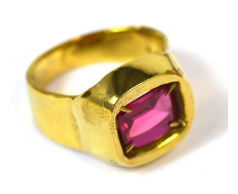 A gentleman's 18ct gold dress ring set with a large emerald cut ruby, size T, approx 17g.