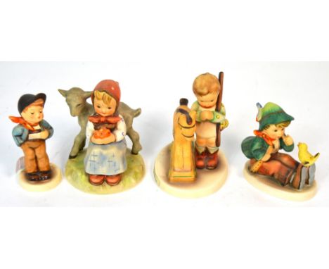 Four Hummel figures to include a young girl seated by a lamb, a little boy singing to a chick, a young boy playing with his r
