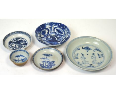 A Chinese blue and white bowl decorated with the central vignette of a figure within a border set with various symbols, beari